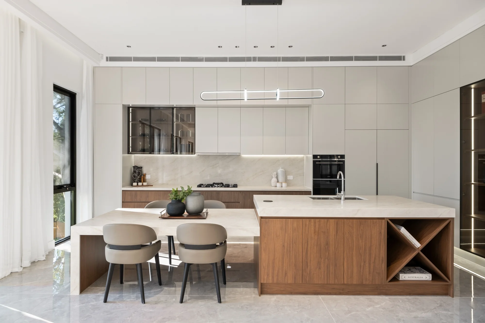 Timber kitchen island with full-height cream cabinetry